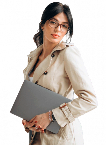young-business-woman-with-laptop-standing-by-window-office